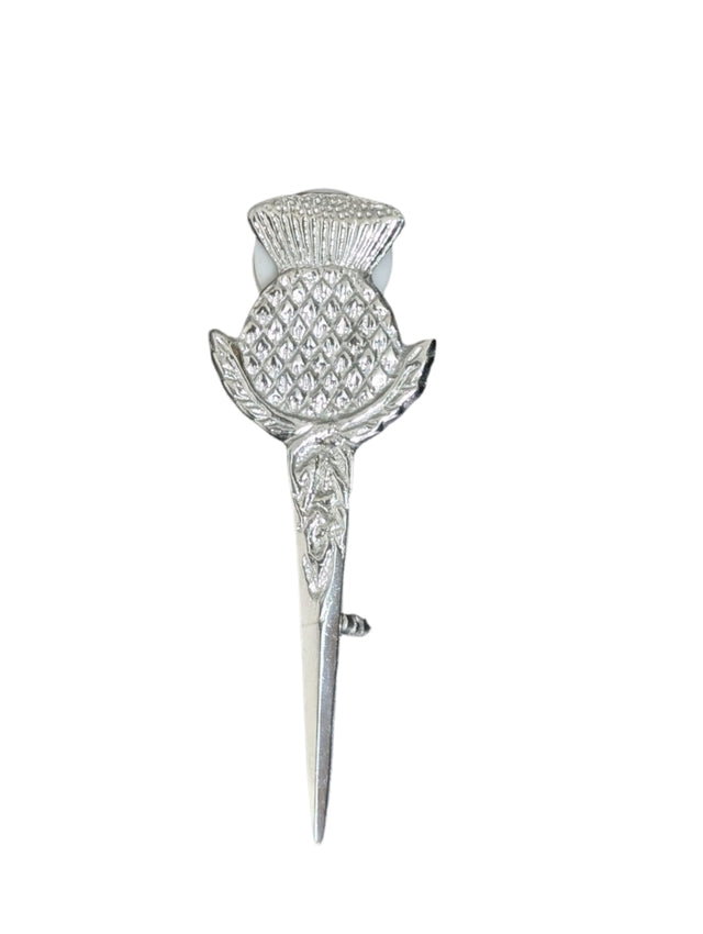 Silver thistle brooch on a textured black background