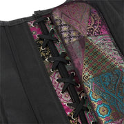 Close-up of a black corset with a colorful patchwork paisley lining, featuring black laces threaded through silver metal eyelets.