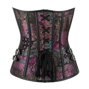 A Victorian-style corset with a multicolor paisley and floral patchwork pattern in purple, pink, and teal, accented by black faux-leather trim, laces, and side buckles, shown against a plain white background.
