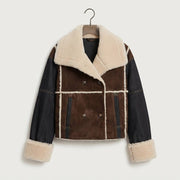 A women's shearling and denim jacket hanging on a wooden hanger against a light gray background. The jacket features dark brown suede panels, dark denim sleeves, and thick cream-colored shearling lining on the collar, cuffs, and panel dividers.