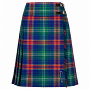 A pleated kilt featuring a vibrant blue, green, and red tartan plaid pattern, with a black belt and silver buckle at the waist and a silver safety pin closure near the hem.