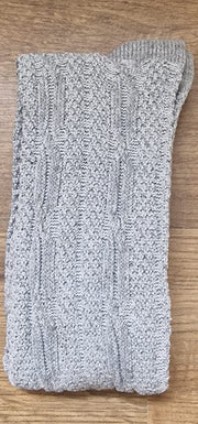 Gray knitted sock on a wooden surface