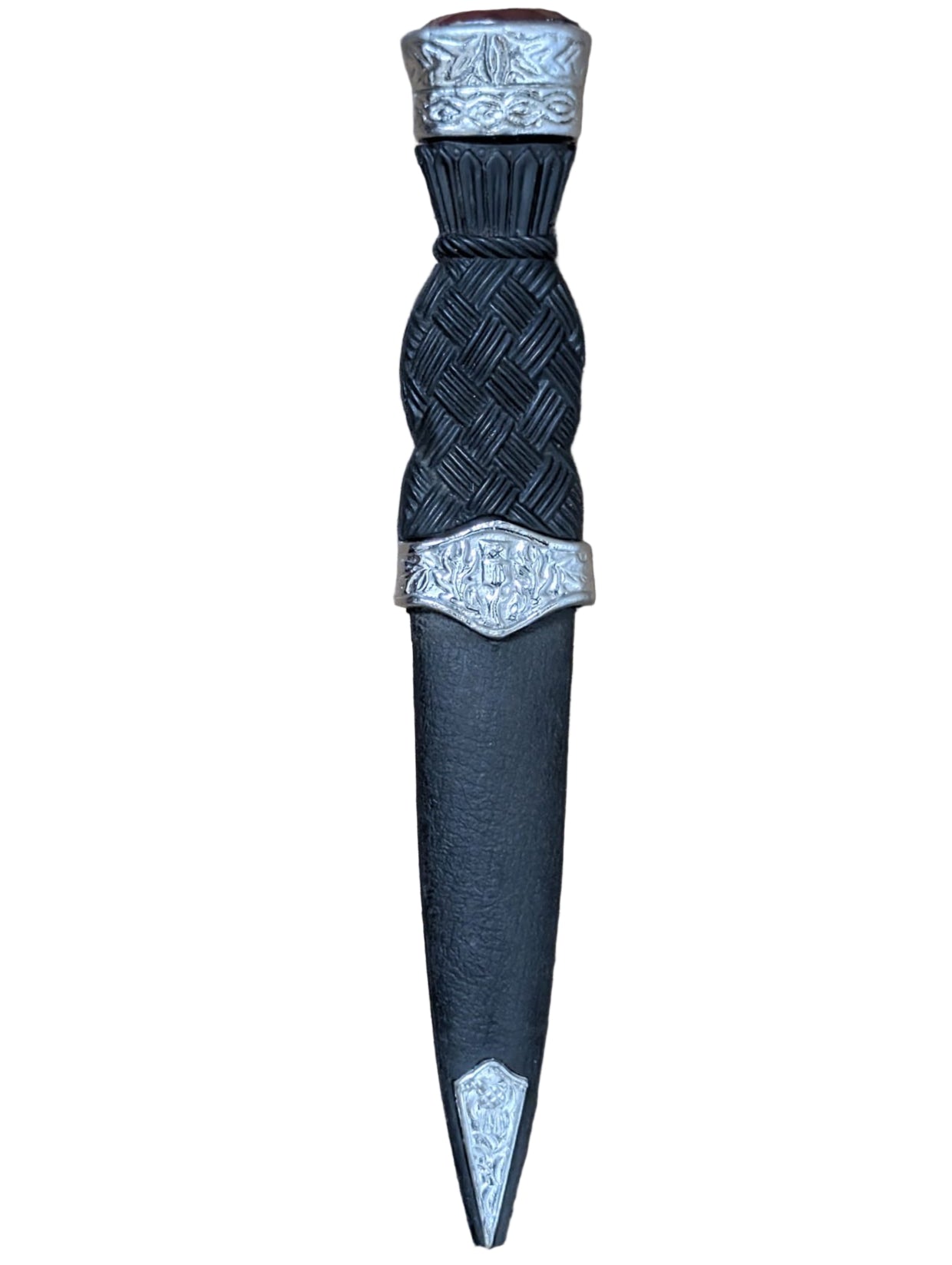 Decorative black and silver kilt pin on a wooden surface