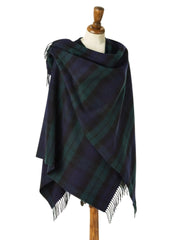 Navy and green plaid shawl on a mannequin against a beige background