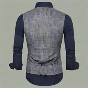 Back view of a plaid vest over a navy shirt on a white background