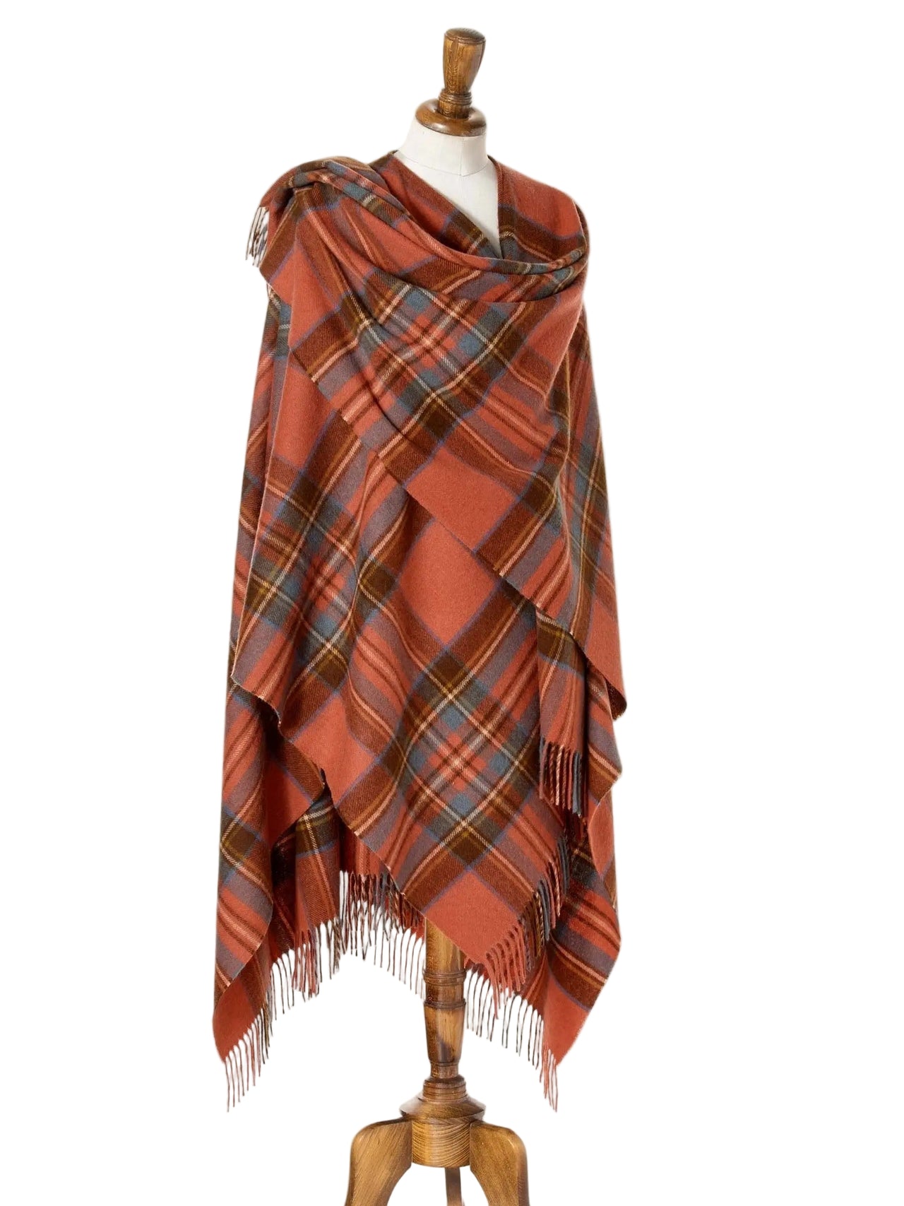 Plaid shawl with fringes on a mannequin against a beige background
